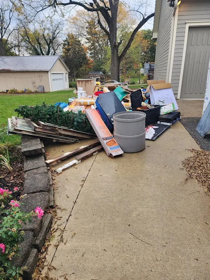 Dumpster being loaded with debris for 10 Yard Dumpster Rental in Brookside